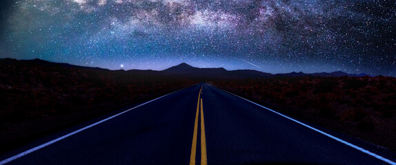 US 93 Alt in Nevada near Wendover vanishes under the Milky Way and a starry sky,