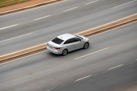 Silver Volkswagen Jetta sedan rear high angle panning shot, German family car driving fast