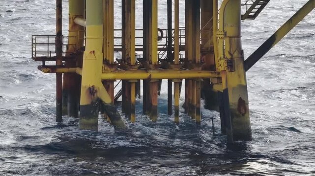 Waves Hit Oil and Gas Producing Slots and Surface Casings at Offshore Platform
