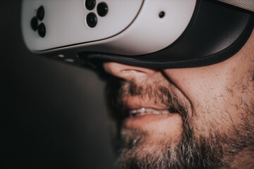 Male individual wearing virtual reality headset, immersed in digital experience, showcasing advanced technology and modern gaming culture, highlighting immersive entertainment and innovation