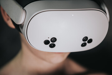 Close-up of a person wearing a modern virtual reality headset, showcasing advanced technology and immersive experience, highlighting the future of digital entertainment and gaming