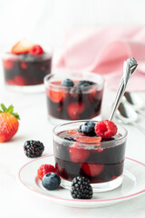Vertical view of sweet mixed berry jelly dessert cups, ready for eating.