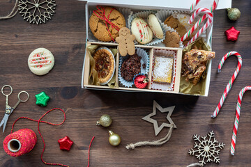 Preparing a homemade baked goods cookie box as a Christmas gift.