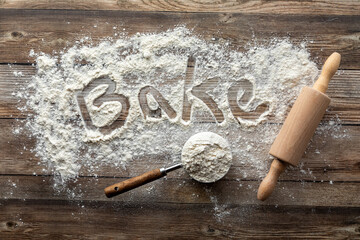 A baking concept image with flour, a rolling pin and a measuring cup.