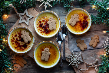 Ramekins containing delicious homemade Creme Brulee topped with gingerbread men.