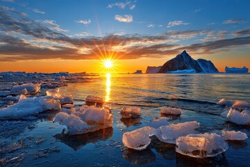 A breathtaking arctic sunset over the icy ocean, casting a golden glow on icebergs and the dramatic mountain landscape, creating a serene, picturesque polar scene.