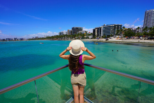 Vacation in Brazilian Caribbean. Young tourist woman on viewpoint in the city of Maceio, Alagoas, Brazil.
