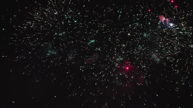 Spectacular fireworks finale creating dramatic patterns in night sky 