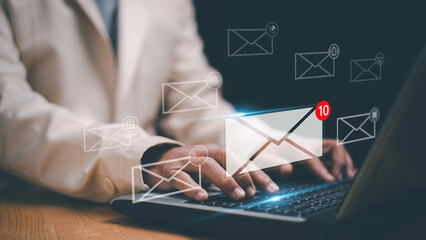 Business email communication concept. Businessman typing on laptop and virtual mail notification icons. Digital messaging, online inbox, customer support, marketing and modern office technology.