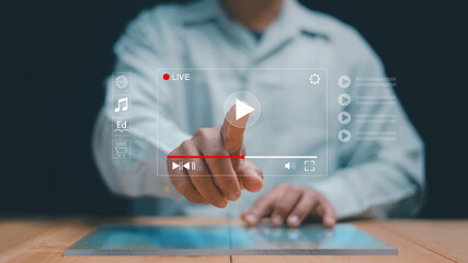 Digital live streaming concept. Man touching virtual play button interface. Online video media, education, entertainment, e-learning and streaming technology for global communication platforms.