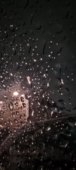 Fototapeta premium Raindrops on glass with soft evening light