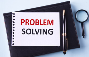PROBLEM SOLVING - word in notepad on black notepad, magnifying glass and pen background