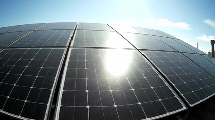 Close up of solar panels on a rooftop under a bright sunny sky capturing renewable energy. - Powered by Adobe