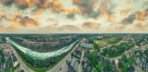 Niagara Falls aerial panorama at twilight showing cascading water and glowing urban skyline © jovannig