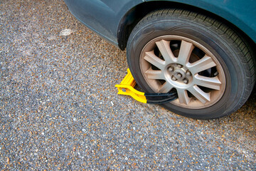 Locked car wheel after traffic fine highlighting parking enforcement and regulations