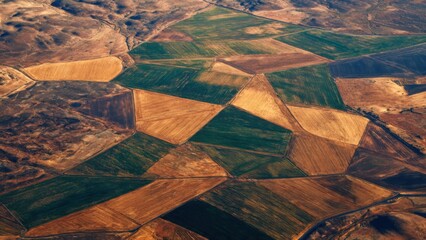Stunning Aerial View of Geometric Agricultural Patterns Across Scenic Countryside Landscape in Autumn Colors