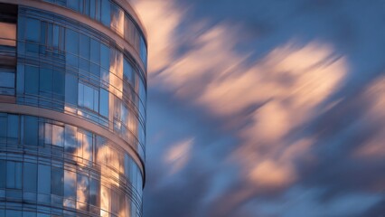 Modern Skyscraper with Reflective Glass Against Dramatic Cloudy Sunset Sky Creating Futuristic Urban Landscape Atmosphere