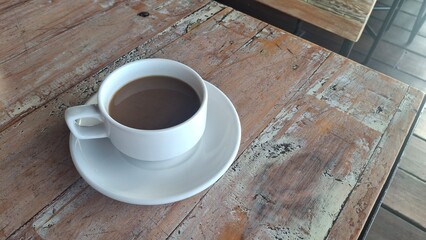 coffee cup on a white table, paired with a stylish hotel breakfast, bathed in soft morning light for an inviting and cozy scene
