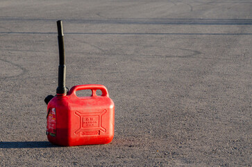 Red Fuel Canister on Asphalt Background