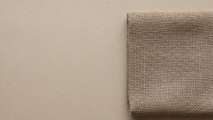 Folded burlap fabric on a light beige surface