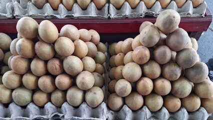 Sawo or Sapodilla Fruits Stacked in Market Display Indonesia