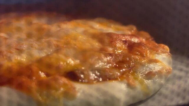 Freshly baked homemade pizza with golden brown crust and gooey cheese