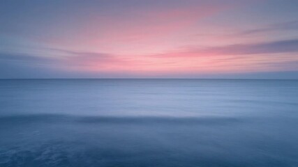 Tranquil seascape at dawn with soft pastel pink and blue hues painting the sky above calm ocean waters, a serene long exposure captures blurred motion and a peaceful horizon - Powered by Adobe