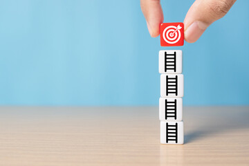 Bullseye is a target of business.Hand putting target board on up arrows which print screen on dice,...