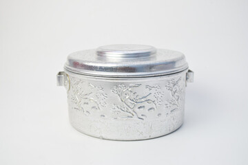 Vintage embossed aluminum container with floral pattern on white background
