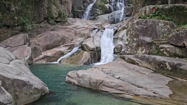 Majestic landscape of Khe Van Waterfall: A hidden natural gem in Binh Lieu, Quang Ninh with white water cascading over massive stone formations.