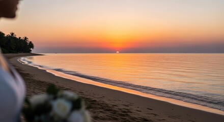 Woman standing on a beach at sunset, holding a bouquet of flowers.