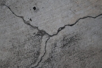 Detailed Close-up of Deep Cracks in Weathered Concrete Surface