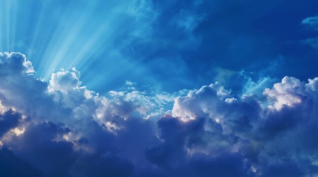 Heavenly blue sky with sun rays breaking through dark clouds