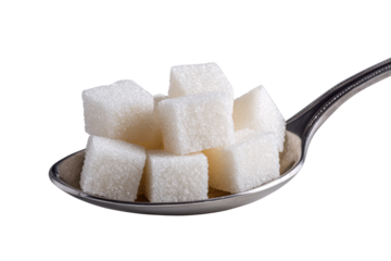 Silver spoon holding pile of white sugar cubes against black background image
