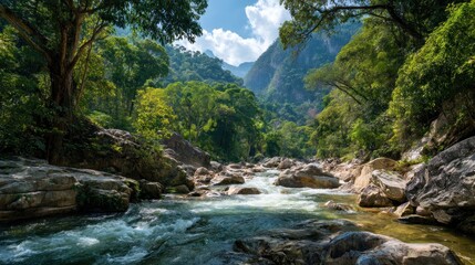 River flows through a rocky gorge; a vibrant tree guards the bank. Majestic mountains form the backdrop