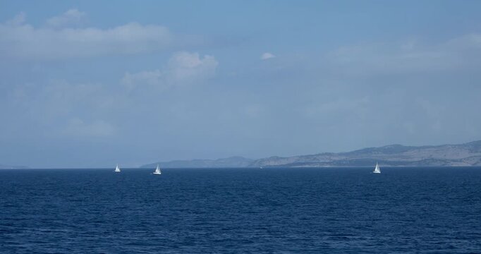 Group of white yacht ship boats with a sail on regata voyage trip in the blue sea