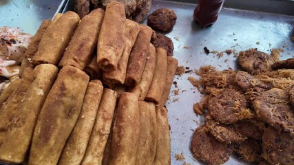 Street food preparation in local market at midday