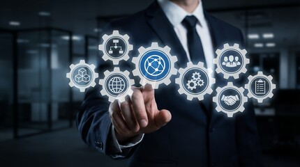 A man in a suit touches a series of interlocking gears displaying icons of global connectivity team collaboration process flow and partnership agreements within an office environment