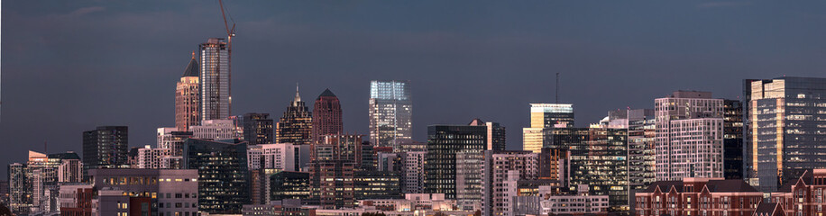 View of the Atlanta skyline showing several prominent buildings, hotels, office towers shortly after sunset.