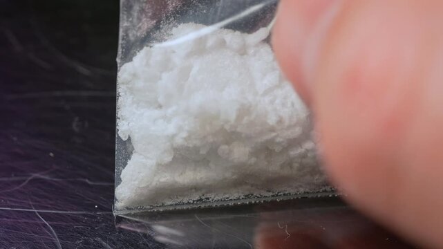 Synthetic opioids crystals like fentanyl or nitazenes drug in the plastic bag. Opioids account for two thirds of drug overdose deaths worldwide. Extremely potent drugs in the hands of the drug user.