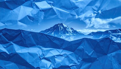 Blue crumpled paper forms a landscape with a mountain and sky