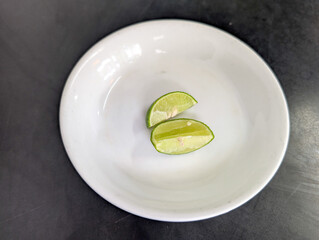 Lime slices served on a white plate