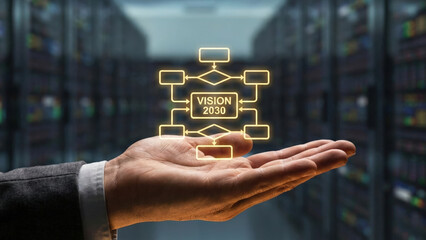 Vision 2030 high level planning concept glowing over business hand in data center futuristic technology strategy focus