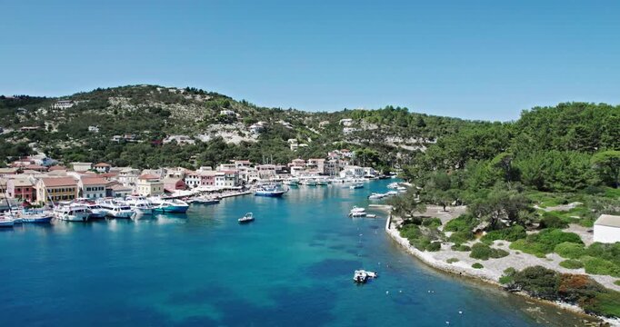 Cinematic aerial shot of famous Gaios town in Paxos at sunny day in Greece. Perfect summer vacation at the famous tourist resort of the Paxos island
