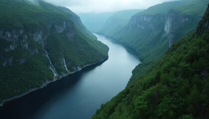 Majestic river flows through green valleys. Steep cliffs covered in lush forest rise on either side of the calm water. Waterfalls cascade down rocky inclines creating serene natural beauty.