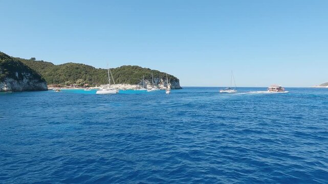 Sailing at iconic tropical paradise beaches of Voutoumi and Vrika with turquoise clear sea, Antipaxos island, Ionian, Greece