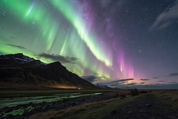 A breathtaking display of green and purple aurora borealis over a mountain landscape