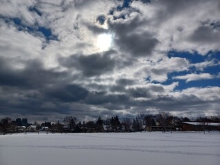 Snow Covered Field Under Cloudy Sky