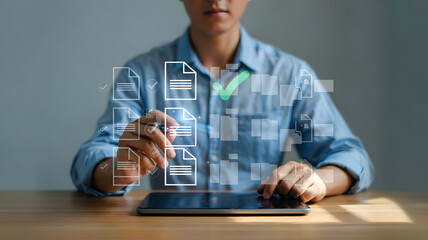 Businessman interacting with digital documents on tablet