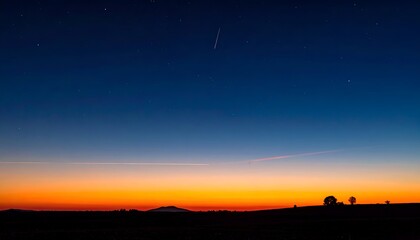 A tranquil twilight scene with a gradient sky transitioning from orange to deep blue